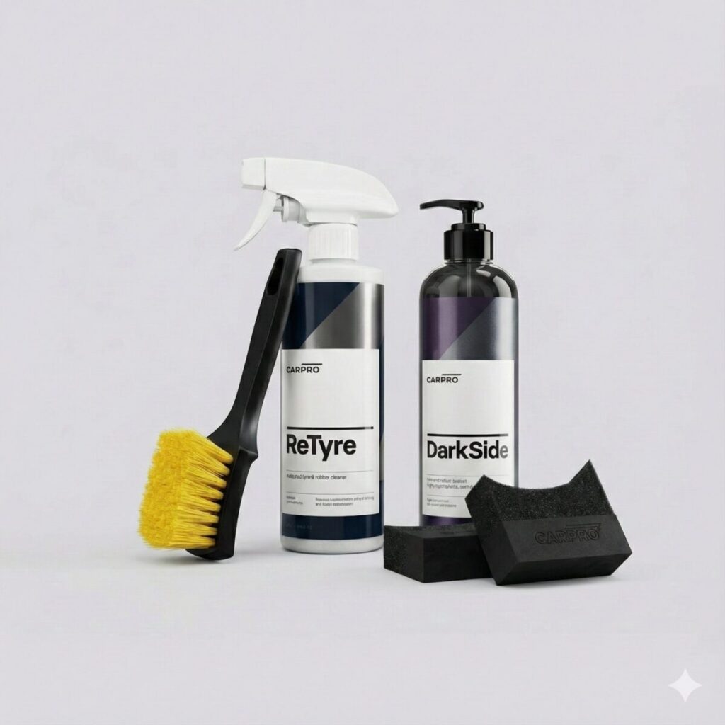 CarPro Black Friday Tire Care Bundle displayed on concrete floor featuring ReTyre, DarkSide, brush and applicators.
